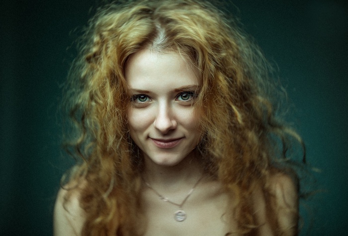 Portrait of a young woman with curly hair