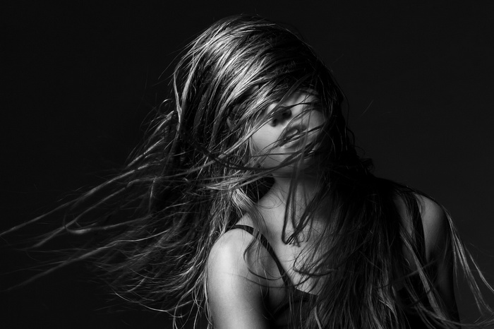 Monochrome portrait of a woman with hair in her face