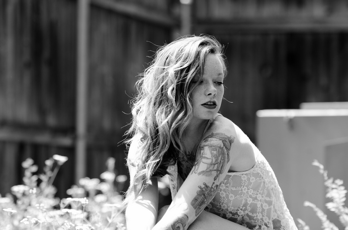 Woman with tattoos and see-through clothing