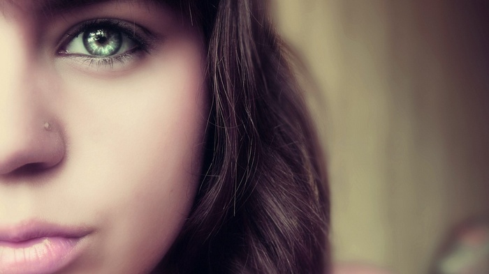 Close-up of a young woman's green eye
