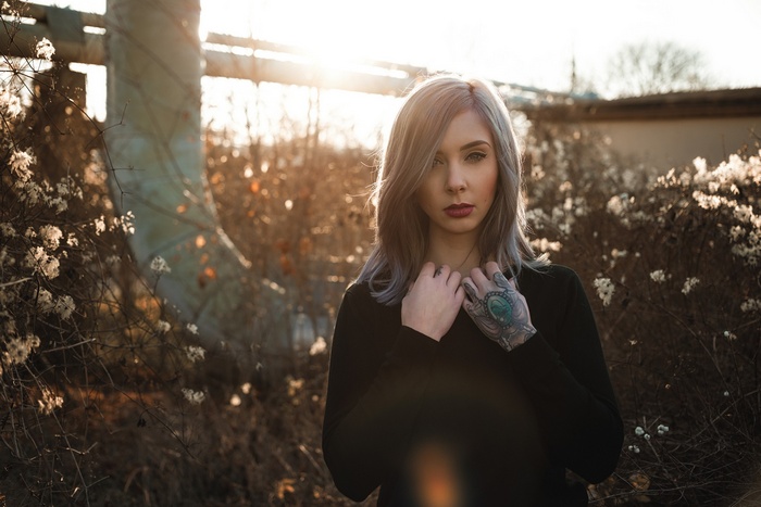 Woman with tattoo at sunset