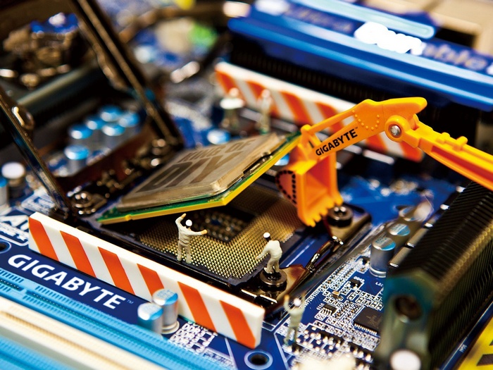 Gigabyte motherboard with miniature construction workers and excavator