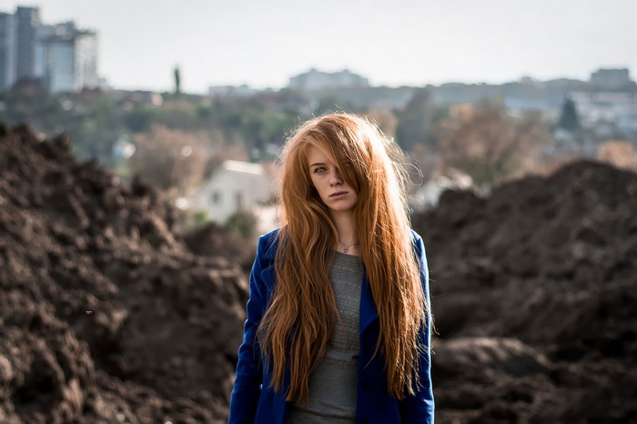 Woman with long red hair in a blue coat