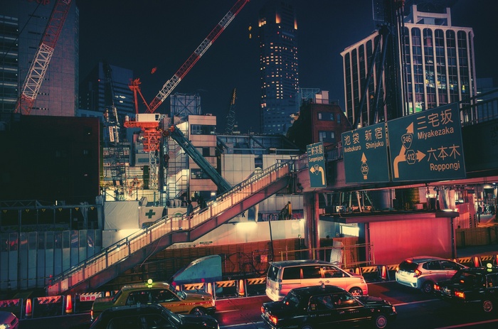 Nighttime Cityscape with Cranes and Traffic in Japan