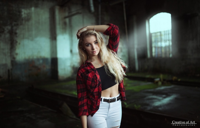 Woman with blonde hair in a plaid shirt