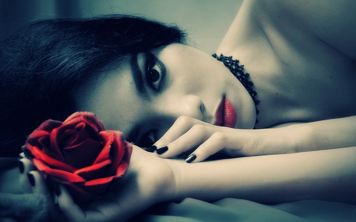 Woman with red rose and black nails