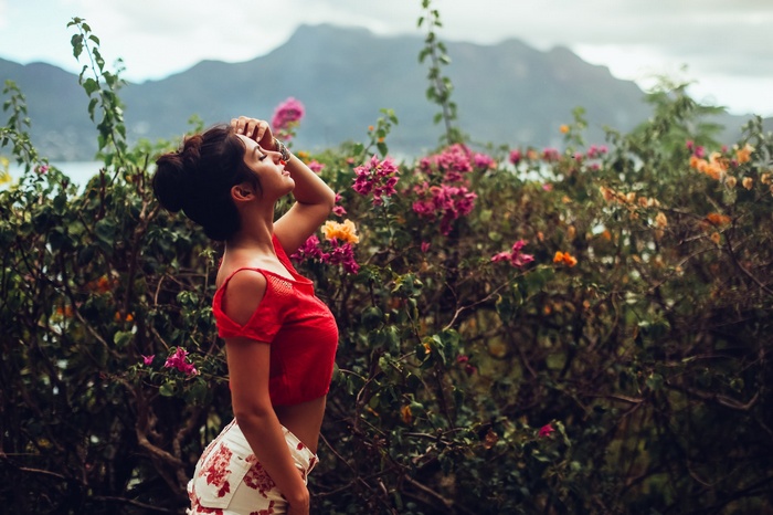 Aurela Skandaj in red top and floral shorts