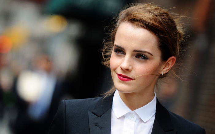 Emma Watson in a black suit and white shirt