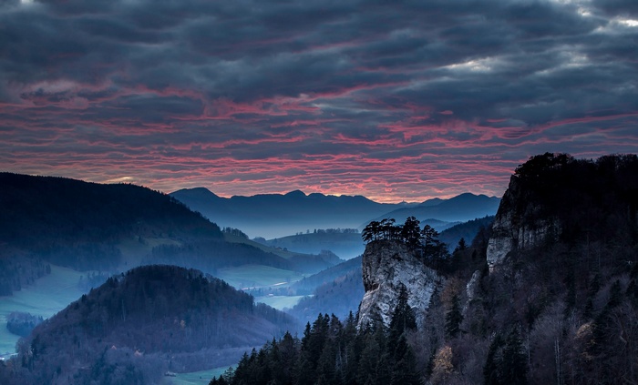 Valley landscape with dramatic clouds at sunset