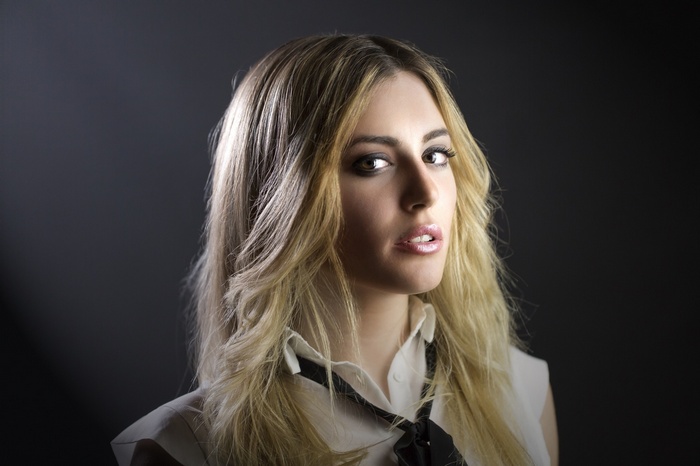 Woman with blonde hair in a white shirt