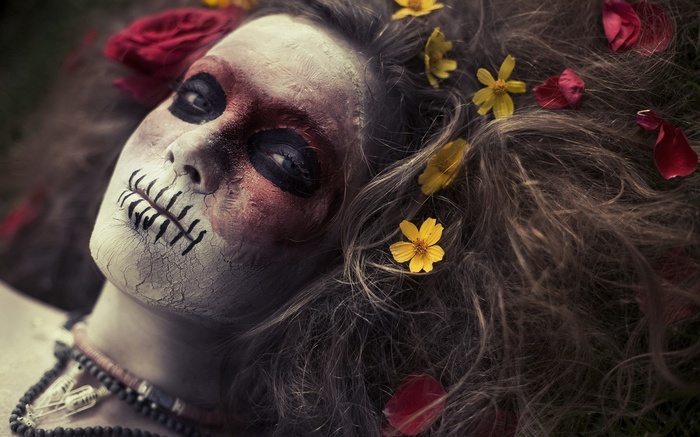 Woman with skull makeup and flowers in hair