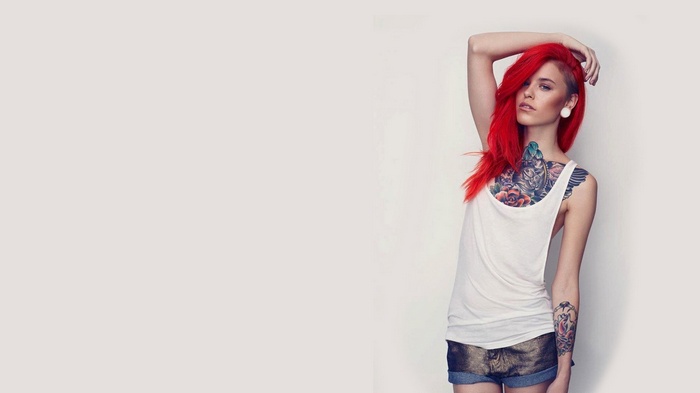 Woman with red hair and tattoos