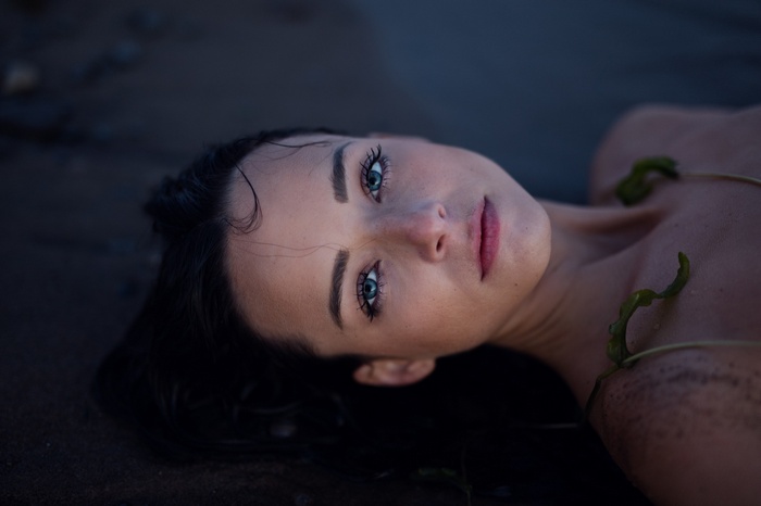 Woman with blue eyes lying on the ground