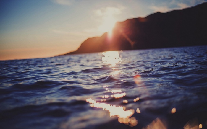 Sunset over the sea with blurred waves