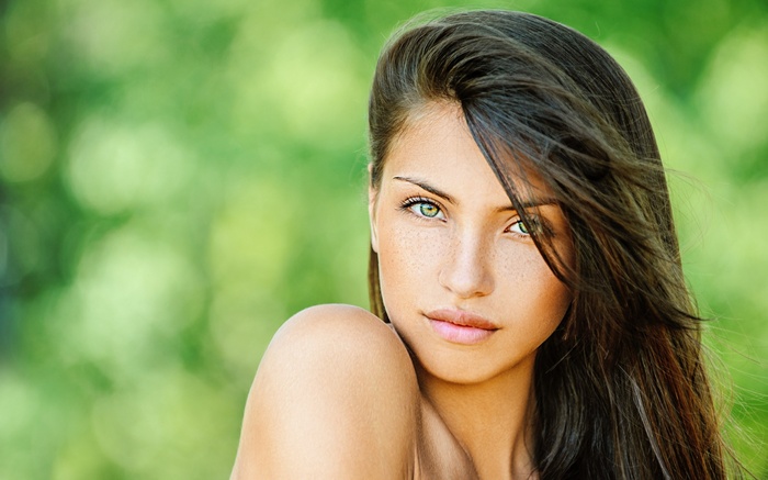 Woman with green eyes and freckles outdoors