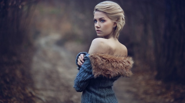 Woman with blonde hair in a forest