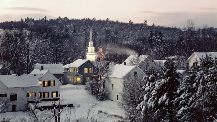 Snowy village with church and Christmas tree