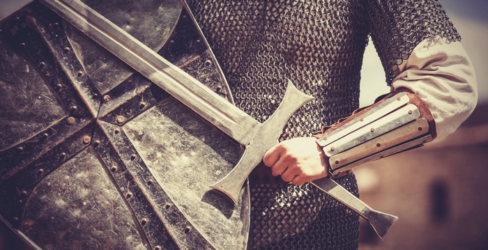 Knight in chainmail armor with sword and shield