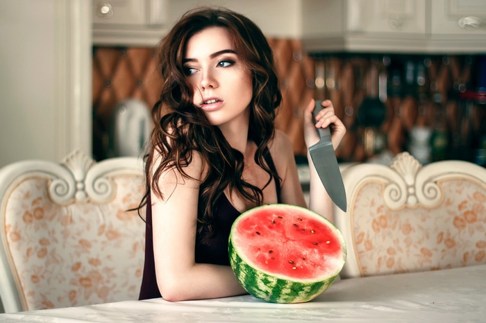 Woman with knife and watermelon