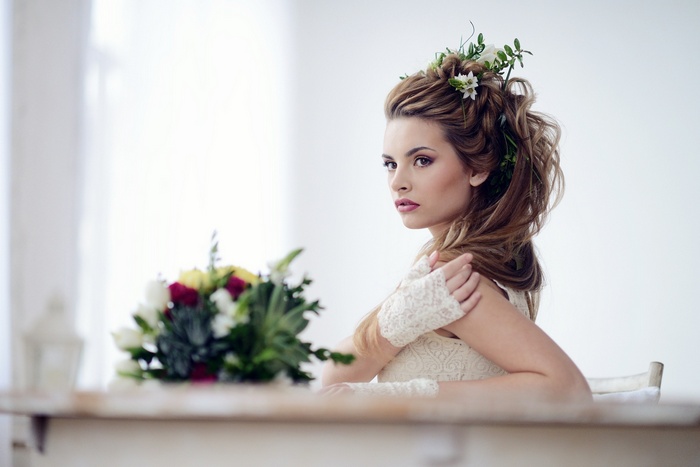 Woman with flowers in her hair and a bouquet