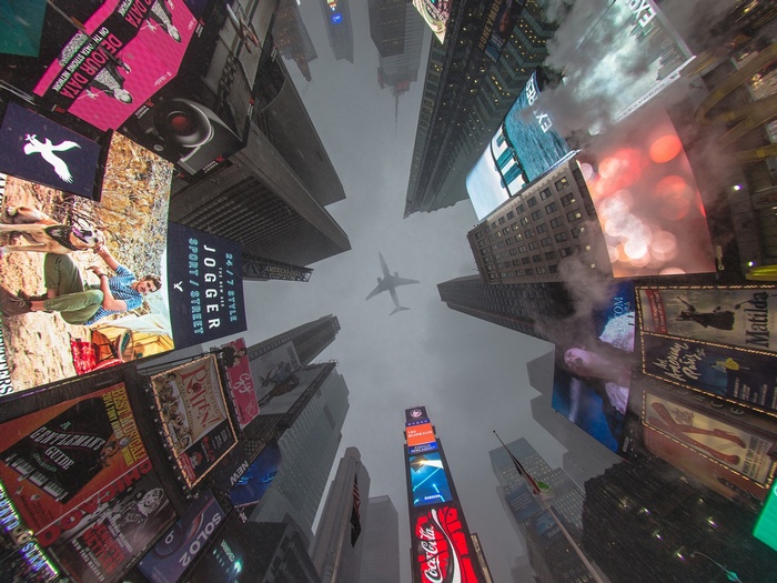Times Square billboards with airplane overhead