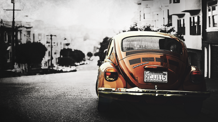 Orange Volkswagen Beetle parked on a street