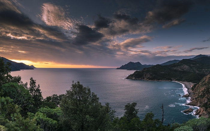 Coastal landscape at sunset with dramatic clouds