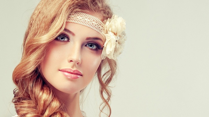 Woman with blonde hair and blue eyes wearing a headband