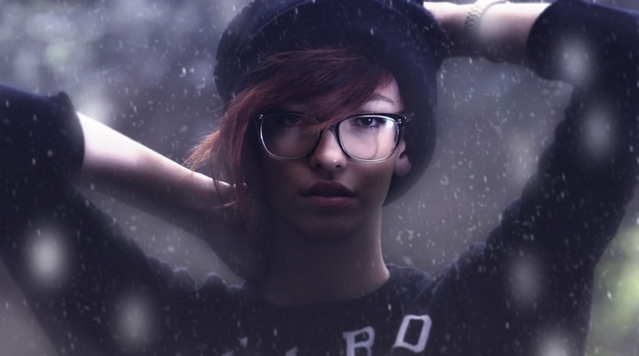 Woman with glasses and hat in the snow