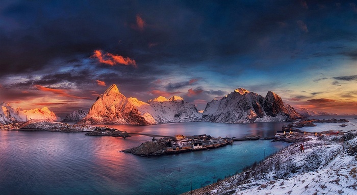 Snowy mountains and villages in Norway at sunset