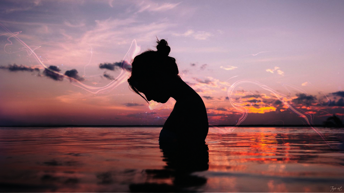 Silhouette of a woman at sunset over the Pacific Ocean