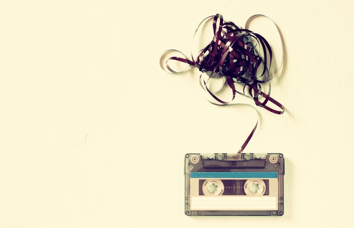 Tangled cassette tape on a light background
