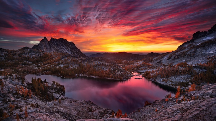 Mountain lake at sunset with vibrant sky