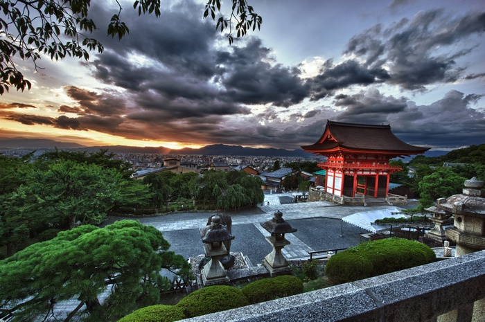 Japanese temple with dramatic clouds at sunset
