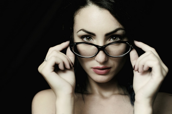 Woman with glasses looking at the camera