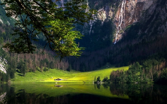 Waterfall cascading down mountains into a lake in Germany