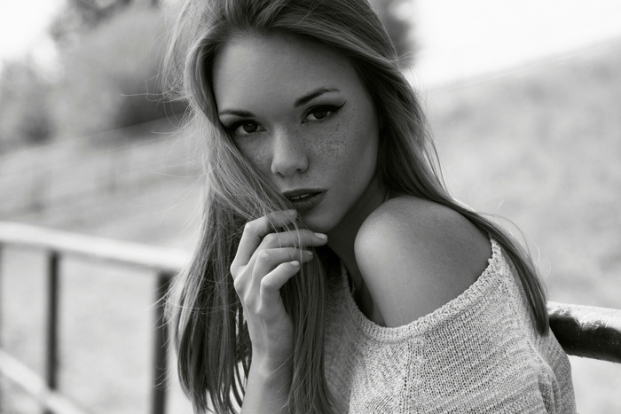 Monochrome portrait of a young woman with freckles