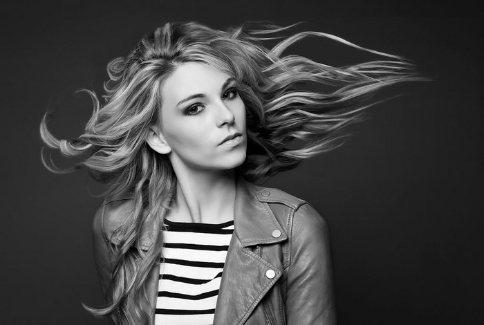 Chloé Roy with flowing blonde hair and leather jacket