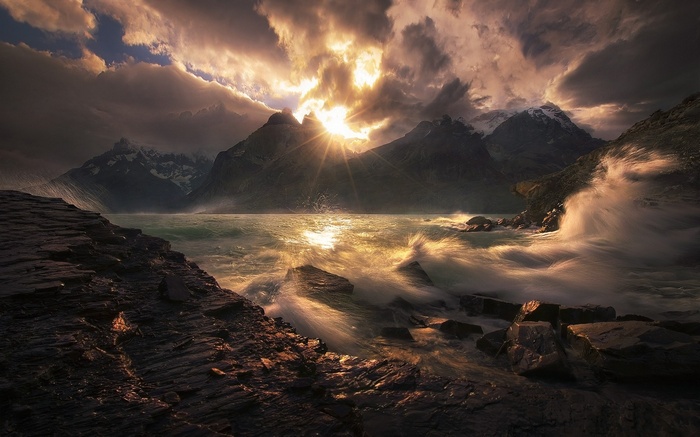 Sunset over mountains and stormy lake in Torres del Paine