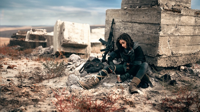 Apocalyptic woman sitting with a rifle