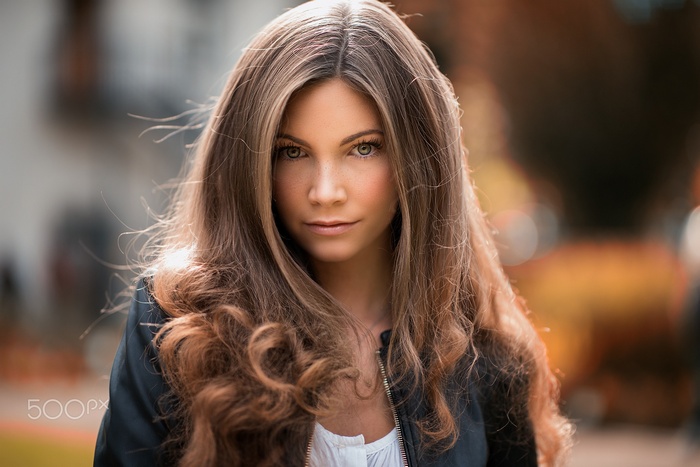 Woman with long brown hair and freckles