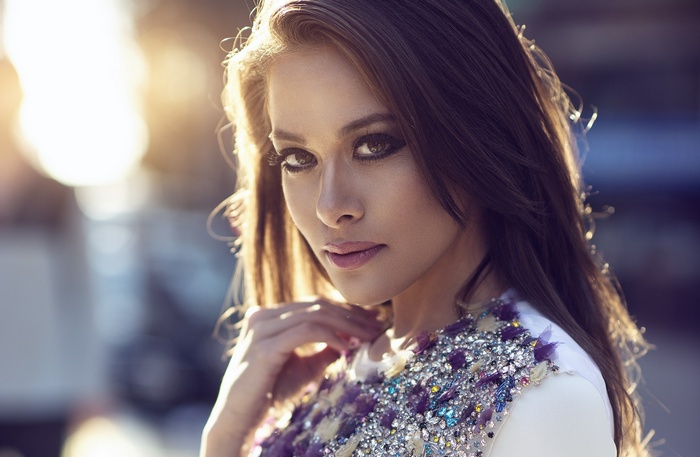 Woman with elaborate beaded dress looking at viewer