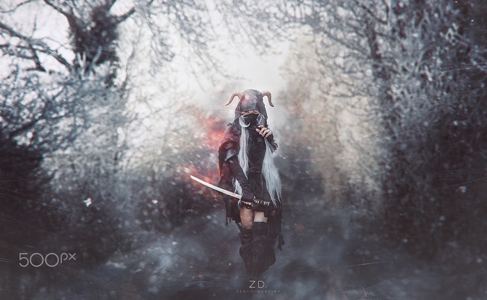 Cosplayer in a dark forest with a sword