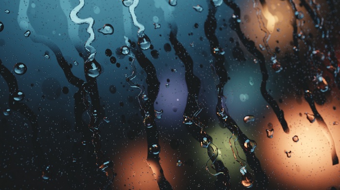 Water drops on glass with blurred lights