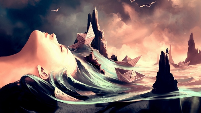 Woman's face emerging from water with origami boats