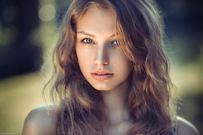 Portrait of a young woman with wavy brown hair