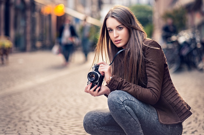 Woman with camera in urban street