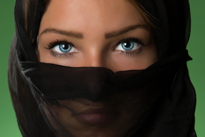 Woman with blue eyes wearing a black veil