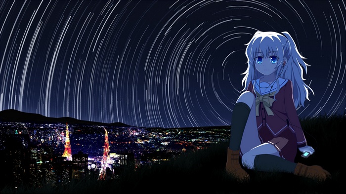 Nao Tomori sits on a hill overlooking a city at night