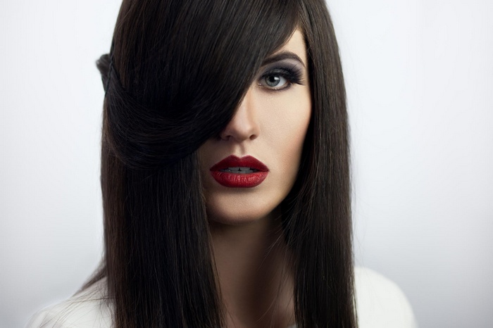 Woman with dark hair and red lipstick